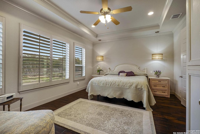 bedroom featuring visible vents, a tray ceiling, and ornamental molding