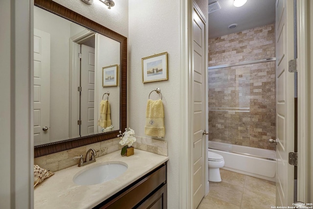 full bathroom featuring vanity, tile patterned floors, toilet, and shower / bathtub combination