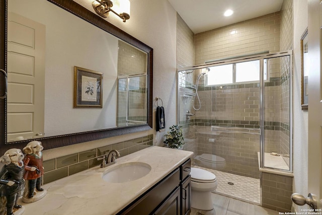 bathroom with vanity, toilet, and a stall shower