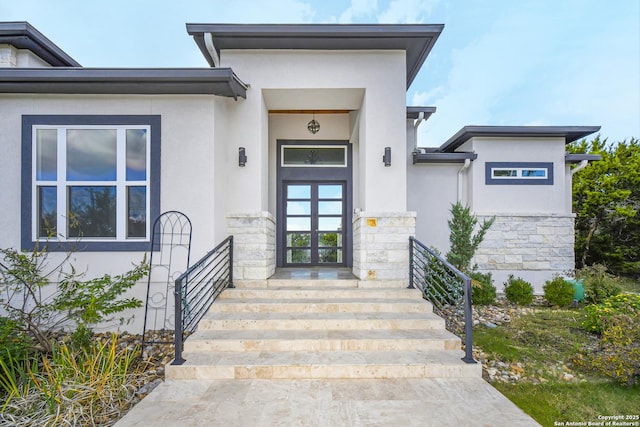 doorway to property with french doors and stucco siding