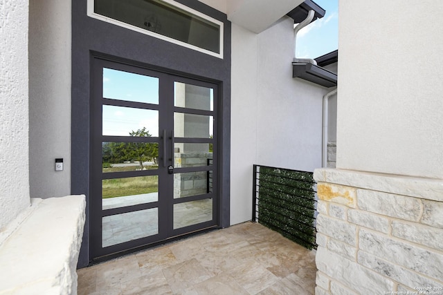 doorway to property with french doors and stucco siding