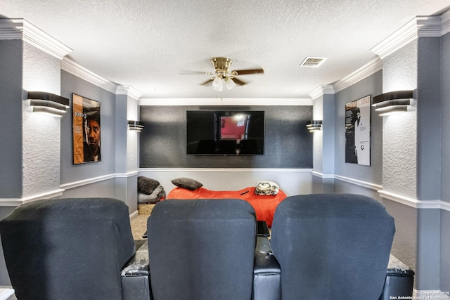 cinema room featuring visible vents, ornamental molding, a textured ceiling, and a textured wall