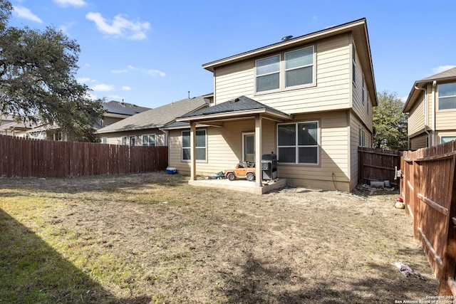 rear view of property with a yard and a fenced backyard