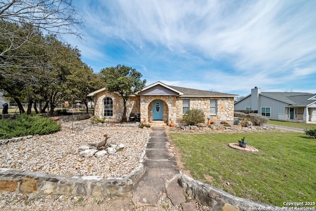 single story home featuring a front lawn and stone siding