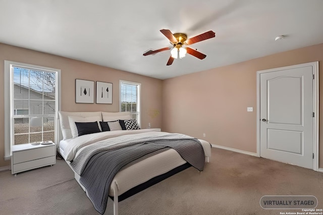 carpeted bedroom featuring ceiling fan and baseboards