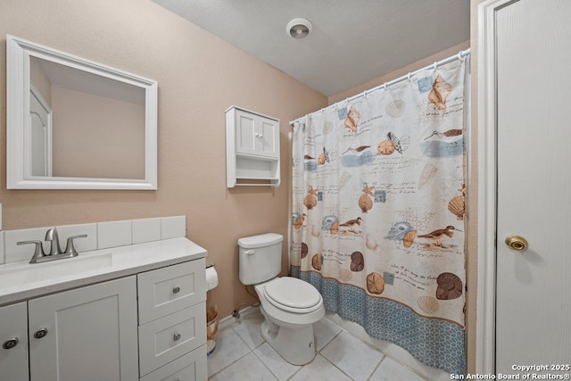 bathroom with tile patterned floors, a shower with shower curtain, toilet, and vanity