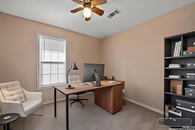 office space with light carpet, visible vents, baseboards, and ceiling fan