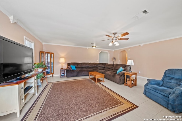 living area with visible vents, baseboards, ornamental molding, and a ceiling fan