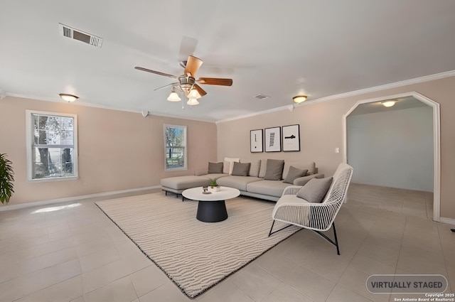 tiled living area with a ceiling fan, arched walkways, visible vents, and ornamental molding