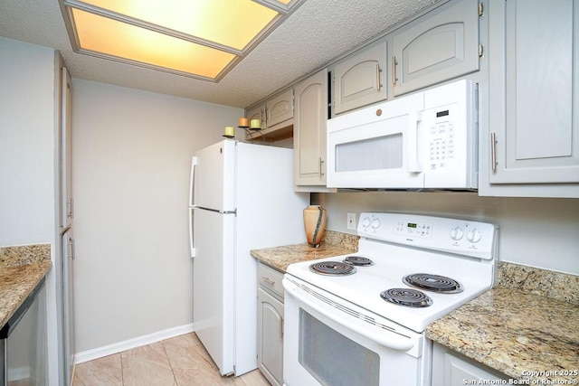 kitchen featuring white appliances and baseboards