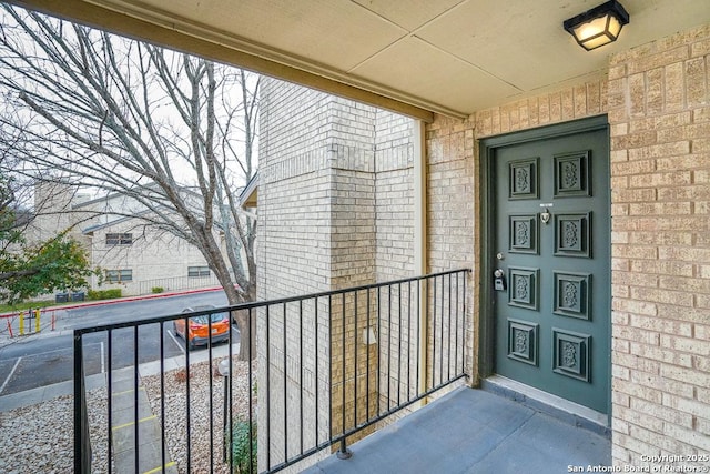 view of exterior entry with brick siding