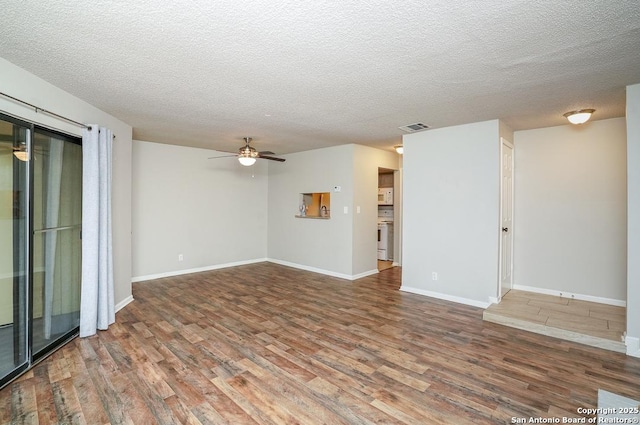 unfurnished room with visible vents, baseboards, and wood finished floors