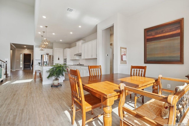 12519 Upton Park, San Antonio, TX 78253 - dining room with visible vents, light wood finished floors, recessed lighting, stairs, and a chandelier