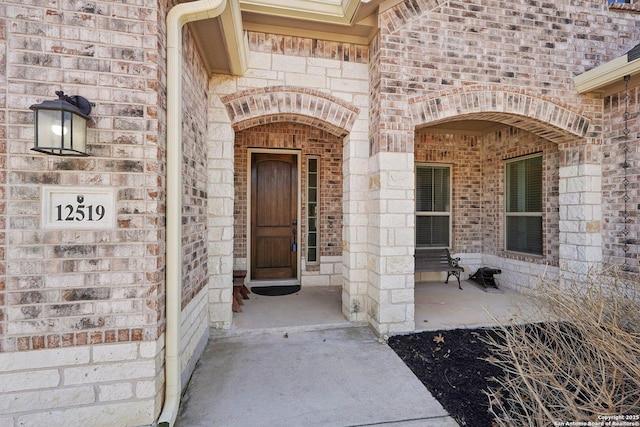 12519 Upton Park, San Antonio, TX 78253 - property entrance featuring covered porch, brick siding, and stone siding