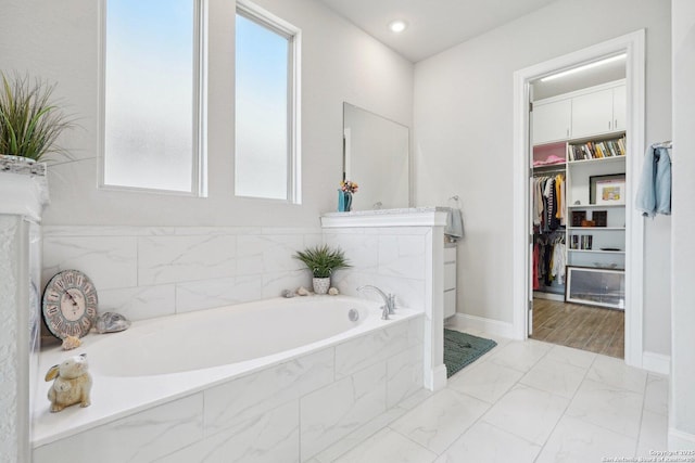 12519 Upton Park, San Antonio, TX 78253 - bathroom featuring a walk in closet, a bath, baseboards, and marble finish floor