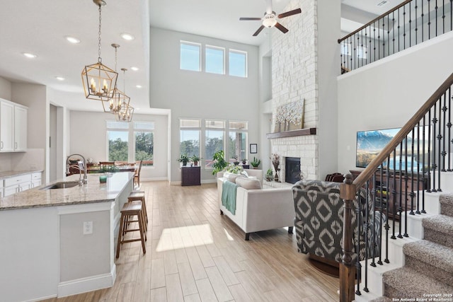 12519 Upton Park, San Antonio, TX 78253 - living room featuring plenty of natural light, light wood-style flooring, and a fireplace
