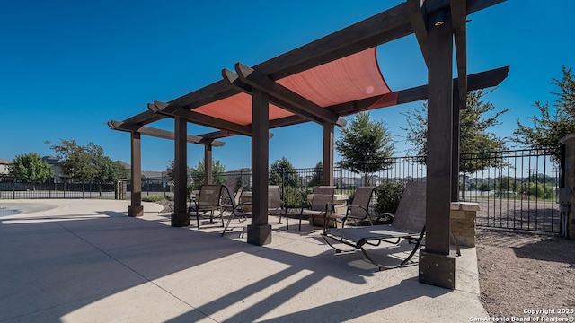 view of patio featuring fence