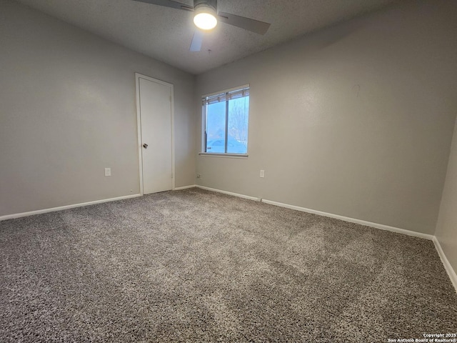 empty room with baseboards, carpet, ceiling fan, and a textured ceiling