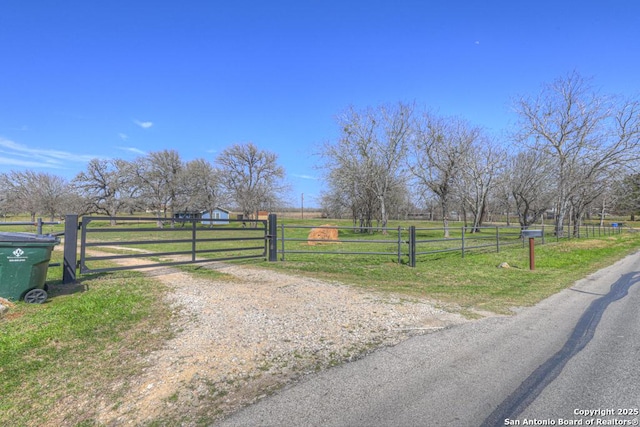 view of street featuring a rural view and a gate