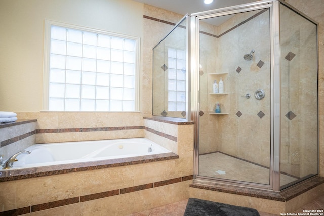 full bathroom featuring a garden tub and a stall shower