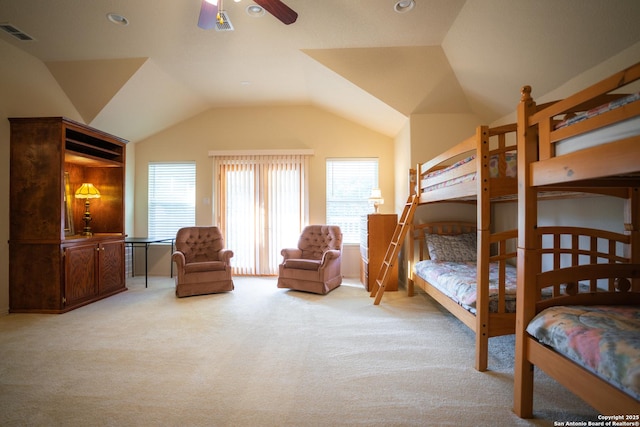 bedroom with lofted ceiling, multiple windows, and visible vents