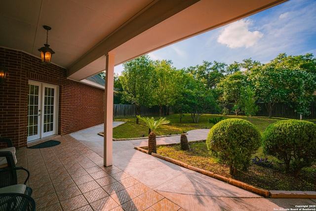 view of patio featuring french doors and fence