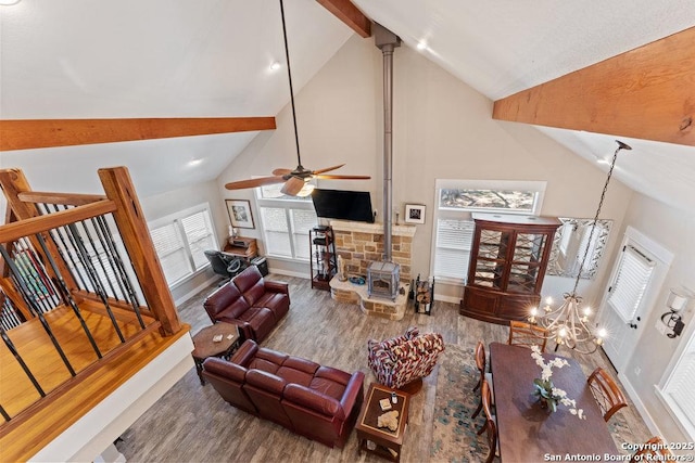 living room featuring baseboards, beam ceiling, high vaulted ceiling, and wood finished floors