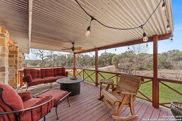 deck with outdoor lounge area and ceiling fan