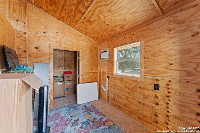 interior space featuring wood ceiling, a wall mounted AC, and vaulted ceiling