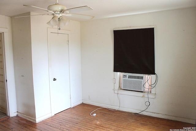 unfurnished bedroom featuring cooling unit, wood finished floors, and a closet