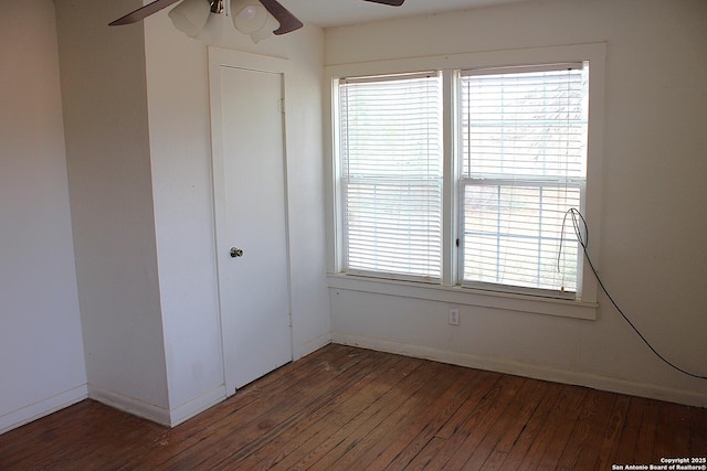 spare room featuring baseboards, wood-type flooring, and ceiling fan