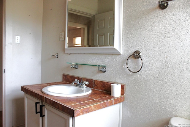 bathroom with toilet and vanity