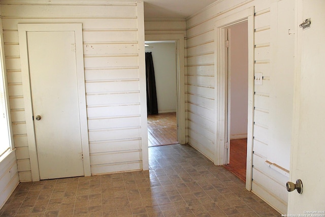 hall featuring wooden walls