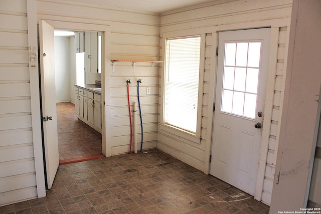 doorway with wood walls