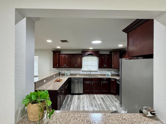 kitchen featuring visible vents, recessed lighting, a sink, light wood-style floors, and appliances with stainless steel finishes