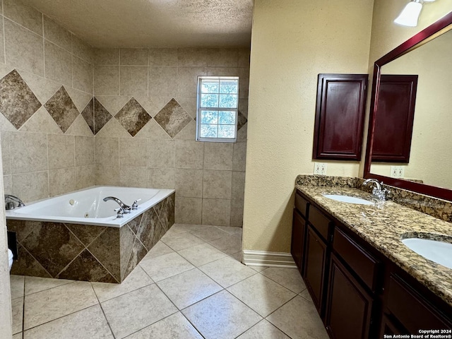 bathroom with a whirlpool tub, double vanity, tile patterned floors, a textured ceiling, and a sink