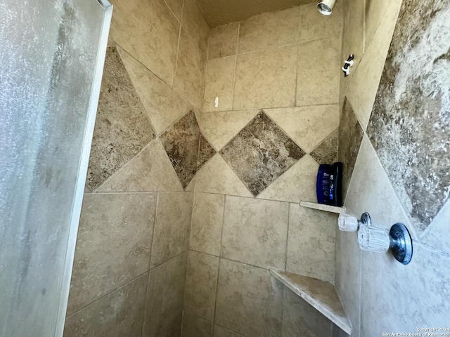 interior details with a tile shower