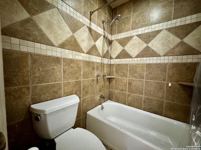 bathroom with tile walls, toilet, and shower / tub combination