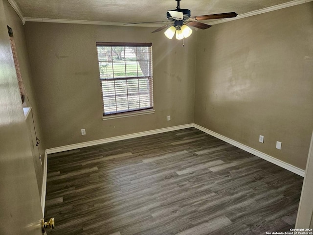 empty room featuring ornamental molding, a ceiling fan, a textured ceiling, dark wood finished floors, and baseboards