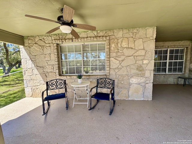 view of patio featuring ceiling fan