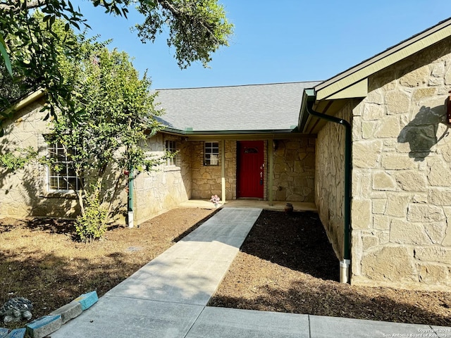 property entrance with stone siding