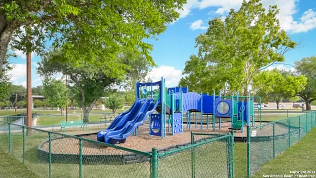 communal playground featuring fence