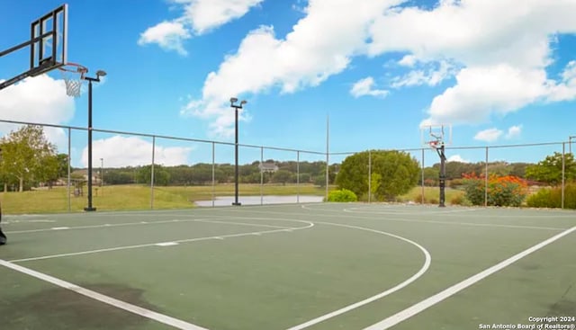 view of basketball court with community basketball court and fence