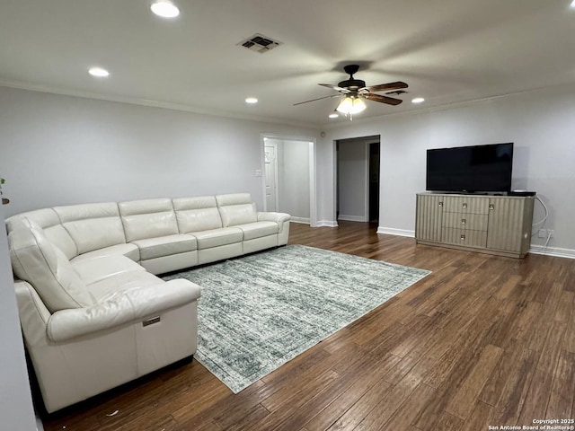 living area with dark wood finished floors, visible vents, recessed lighting, and baseboards