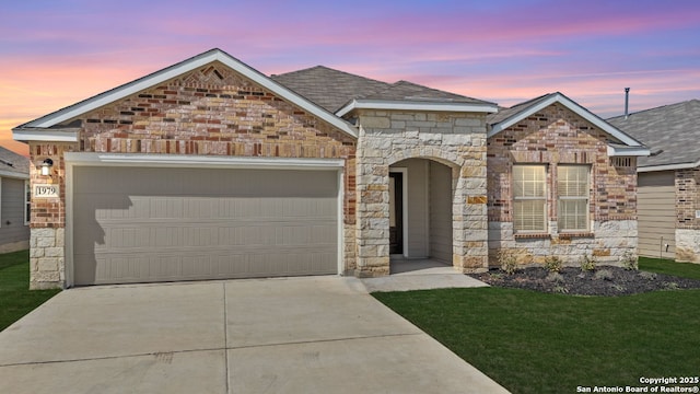 view of front of home with stone siding, concrete driveway, an attached garage, a shingled roof, and brick siding