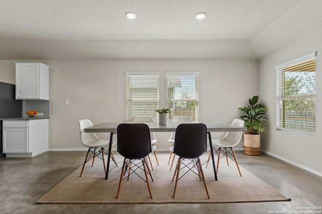 dining room featuring recessed lighting, concrete floors, and baseboards