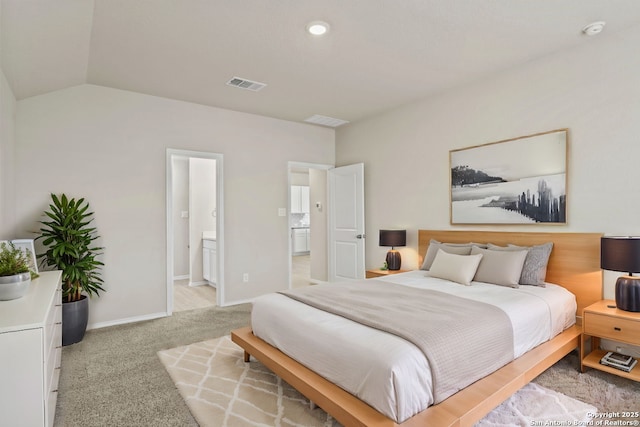 bedroom featuring baseboards, visible vents, ensuite bath, lofted ceiling, and light carpet