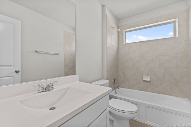 bathroom featuring tub / shower combination, toilet, and vanity