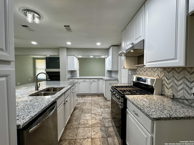 kitchen with under cabinet range hood, visible vents, appliances with stainless steel finishes, and a sink