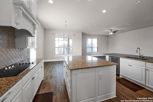 605 Albarella, Cibolo, TX 78108 - kitchen with stainless steel dishwasher, black electric cooktop, ceiling fan, a center island, and dark wood-style floors